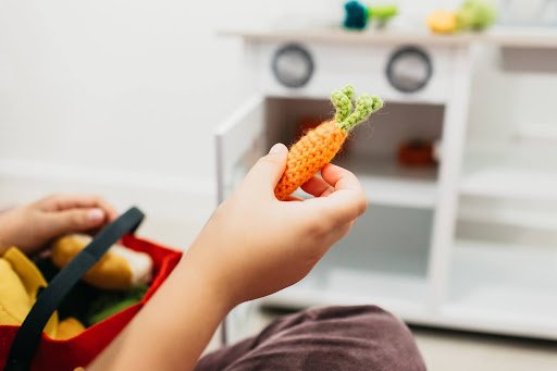 A child holding a carrot