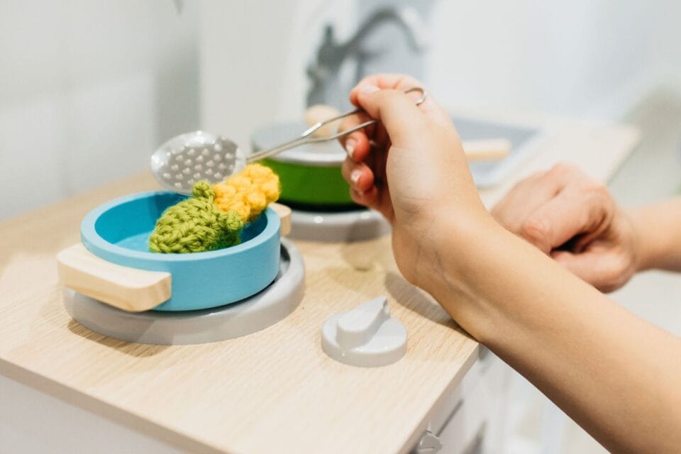 A child playing with pretend food at occupational Therapy