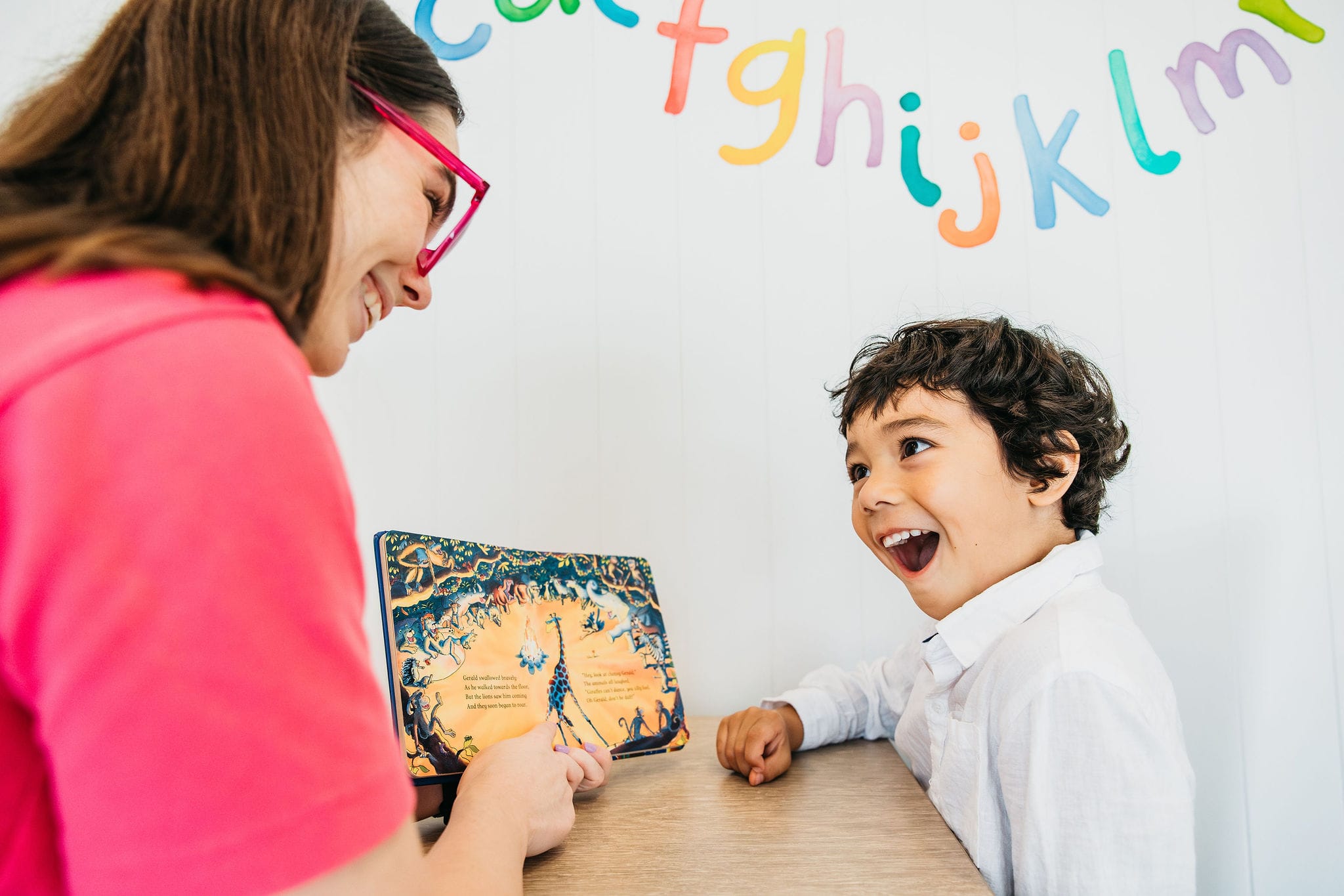 A child reading a book aloud for language development