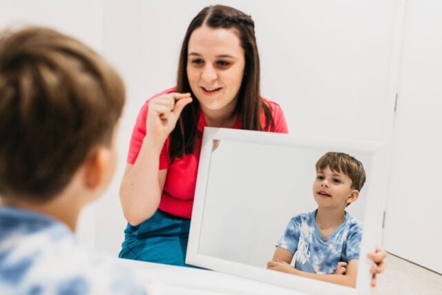 Speech pathologist teaching pronunciation mouth movements