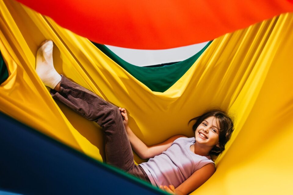 A child playing in a Hammock at BillyLids Therapy