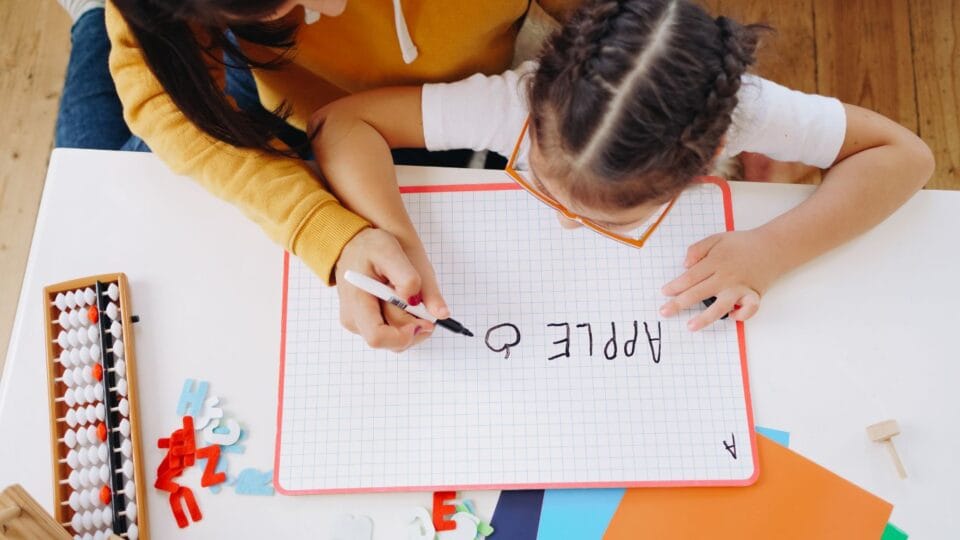 Child at speech therapy practising writing