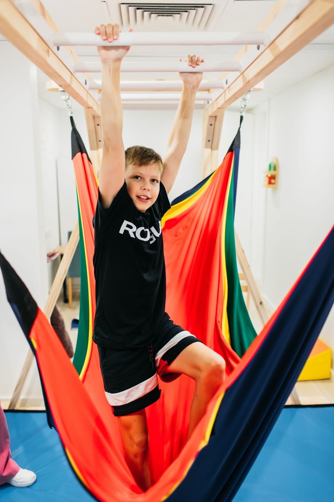 Child practising motor skills on a monkey bar