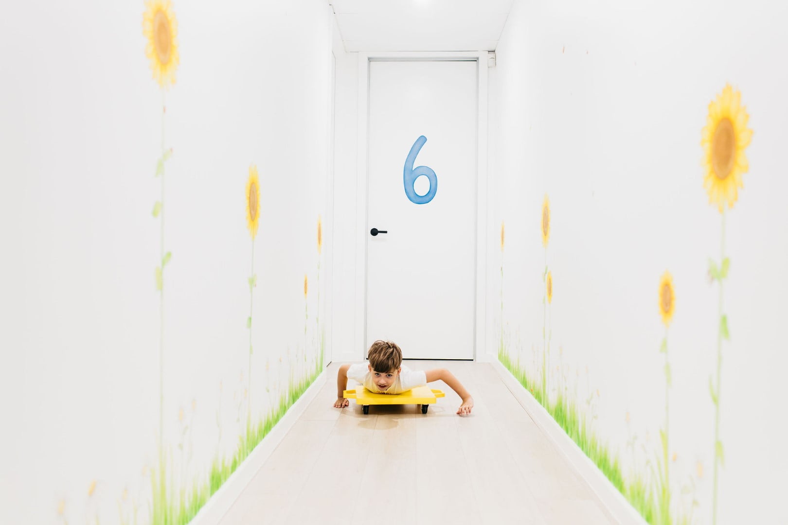 Child pushing themselves on a board