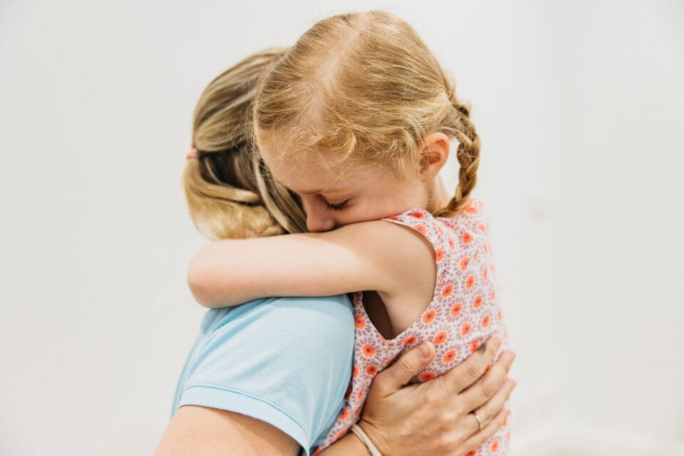 Nonverbal child hugging speech pathologist