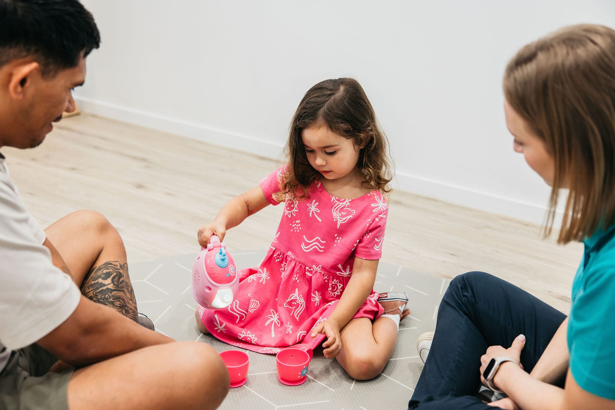 child playing with tea cups in occupational therapy