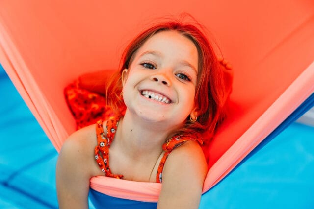 norman-park-child-smiling-in-sensory-swing